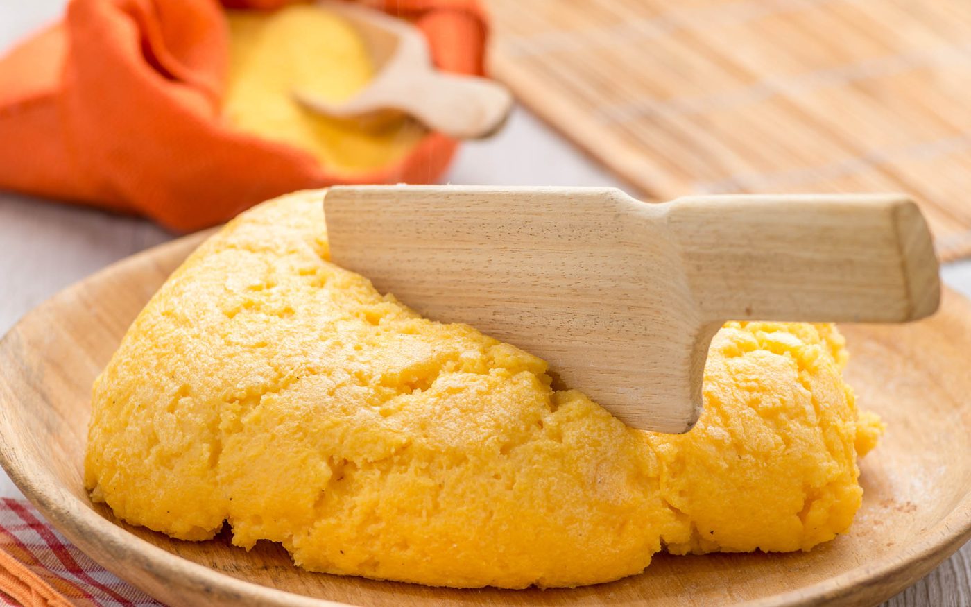 Yellow polenta on wooden plate